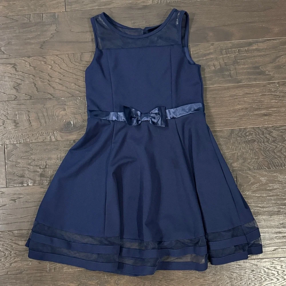 calvin klein navy blue dress Preloved Dresses Mesh detailing at the top and bottom and a decorative bow around the waist give this Calvin Klein dress an elegant finish for any holiday party or special occasion Zip closure Calvin Klein Women's Foldover-Neck Front-Slit